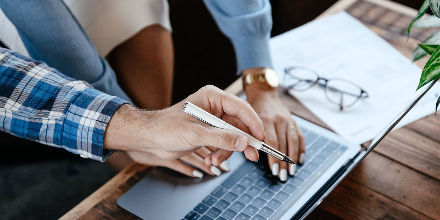 two people working on business insights on a laptop computer